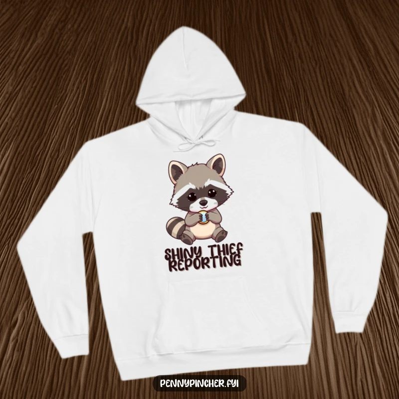 Funny raccoon hoodie, a mischievous character captivated by a shiny button, warm and humorous apparel, perfect gift.
