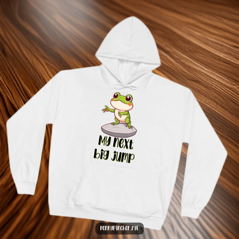 Funny hoodie depicting a clever frog character using a large coin as a stepping stone, radiating a humorous sense of ingenuity and forward momentum.