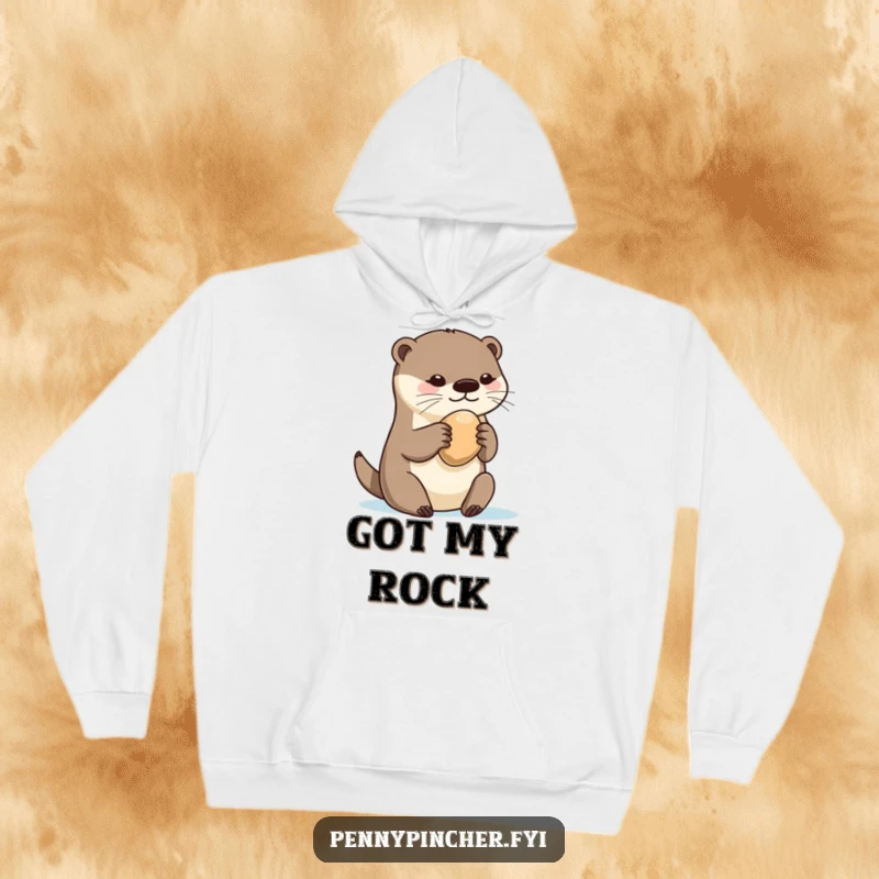 Funny otter hoodie, fiercely but charmingly clutching a single, perfect pebble, embodying a playful guardian of treasures.